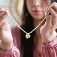 Model Holding Personalised Double Heart Miyuki Bead and Freshwater Seed Pearl Necklace