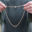 Model Holding Round Clasp and Hoop Necklace in Gold