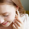 Model Wearing Statement Ivory Freshwater Pearl Hoop Earrings From Lisa Angel