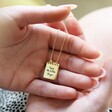 Hands Holding Engraved Personalised Sterling Silver Notebook Pendant Necklace