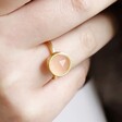 Close Up of Model Wearing Adjustable Rose Quartz Stone Ring in Gold