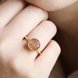 Close Up of Model Wearing Adjustable Strawberry Quartz Stone Ring in Gold