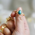 Model Holding Adjustable Teardrop Turquoise Stone Ring in Gold