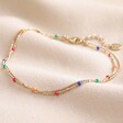 Rainbow Enamel Ball Chain Layered Anklet in Gold on Beige Coloured Fabric