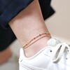 Model Wearing Rainbow Enamel Ball Chain Layered Anklet in Gold with Beige Background