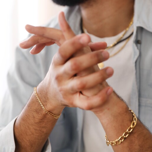 Model Wearing Chunky Curb Chain Bracelet with Other Gold Chain