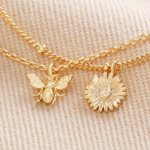Close Up of Pendants on Set of 2 Daisy and Bee Chain Bracelets in Gold