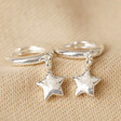 Antiqued Effect Star Charm Huggie Hoop Earrings in Silver on Beige Fabric