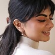 Antiqued Effect Star Charm Huggie Hoop Earrings in Silver on Model