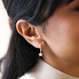 Model Wears Antiqued Effect Star Charm Huggie Hoop Earrings in Silver