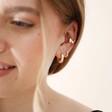 Butterfly Ear Cuff in Gold on Model Against Neutral Background with Other Earrings
