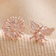 Mismatched Daisy and Bee Stud Earrings in Rose Gold on Beige Fabric