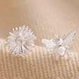 Mismatched Daisy and Bee Stud Earrings in Silver on Beige Fabric
