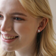 Model Smiling Wearing Daisy Stud from Mismatched Daisy and Bee Stud Earrings in Silver