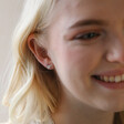 Model Smiling Wearing Bee Stud from Mismatched Daisy and Bee Stud Earrings in Silver