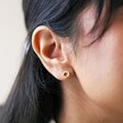 Close Up of Model Wearing Organic Russian Ring Molten Stud Earrings in Gold with Neutral Background
