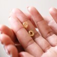 Model Holding Organic Russian Ring Molten Stud Earrings in Gold in Between Fingers