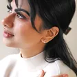 Model Wearing Organic Russian Ring Molten Stud Earrings in Rose Gold Face Turned to Side