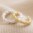Twisted Rope Ear Cuff in Silver Next to Gold Version on Neutral Fabric