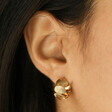 Model Wearing Shell Huggie Hoop Earrings in Gold