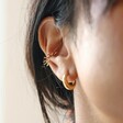 Close Up of Model Wearing Sun Ear Cuff in Gold with Hoop Earrings