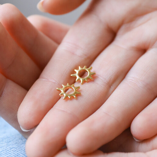 Model Holding Sunbeam Stud Earrings in Gold