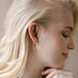 Textured Hoop Earrings in Gold on Model with Hand Under Chin