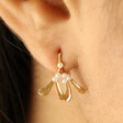 Close Up of Tiny Pearl Mistletoe Stud Earrings in Gold on Model