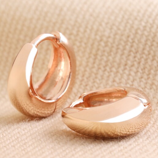 Close Up of Wide Domed Huggie Hoops on Natural Coloured Fabric