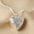3D Molten Heart Pendant Necklace in Silver on Beige Fabric