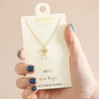 Model Holding September Birth Flower Pendant Necklace in Gold on Card