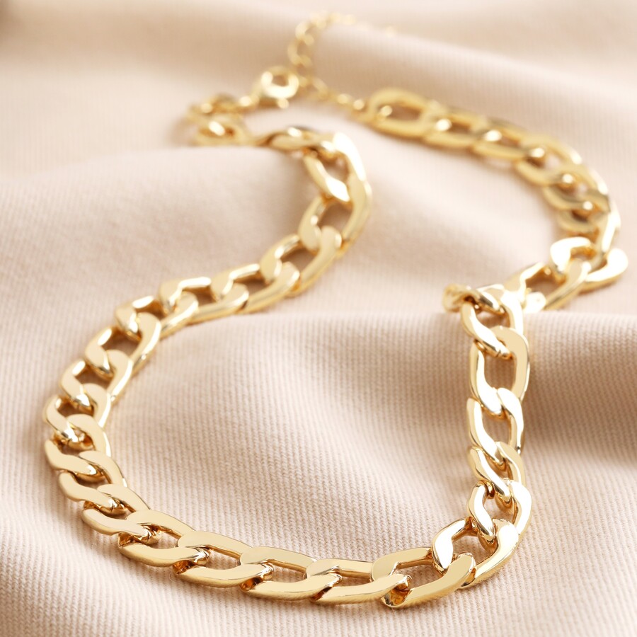 Chunky Chain Necklace in Gold on top of beige coloured fabric