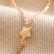 Close Up of Star Charm on the Crystal Moon and Star Lariat Necklace in Gold