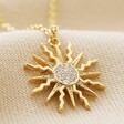 Crystal Sunshine Pendant Necklace in Gold on Beige Fabric