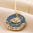 Close Up of Pendant on Enamel Talisman Evil Eye Pendant Necklace in Gold on Beige Fabric