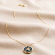Enamel Talisman Evil Eye Pendant Necklace in Gold Full Length on Beige Fabric