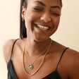 Smiling Model Wearing Enamel Talisman Evil Eye Pendant Necklace in Gold With Other Gold Jewellery