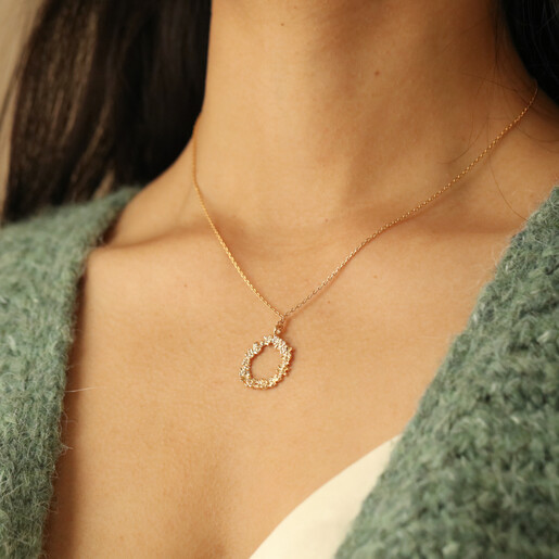 Model Wearing Floral Halo Pendant Necklace in Gold with Green Cardigan