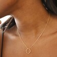 Close Up of Hammered Halo Pendant Necklace in Gold on Model