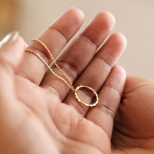 Model Holding Hammered Halo Pendant Necklace in Gold
