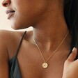 Close Up of Heart Disc Pendant Necklace in Gold on Model