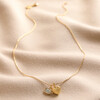Heart and Moonstone Pendant Necklace in Gold Full Length on Beige Coloured Fabric