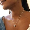 Close Up of Heart and Moonstone Pendant Necklace in Silver on Model