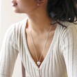 Model Wearing Large 3D Molten Heart Pendant Necklace in Silver with Beige Jumper
