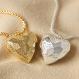 Large 3D Molten Heart Pendant Necklaces in Silver and Gold on Beige Fabric