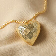 Large 3D Molten Heart Pendant Necklace in Gold on Beige Fabric