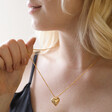Model Wearing Large 3D Molten Heart Pendant Necklace in Gold with Black Top