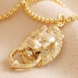 Lion Door Knocker Pendant Necklace in Gold on Neutral Fabric
