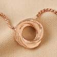 Organic Molten Russian Ring Pendant Necklace in Rose Gold on Beige Fabric