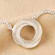 Organic Molten Russian Ring Pendant Necklace in Silver on Neutral Fabric
